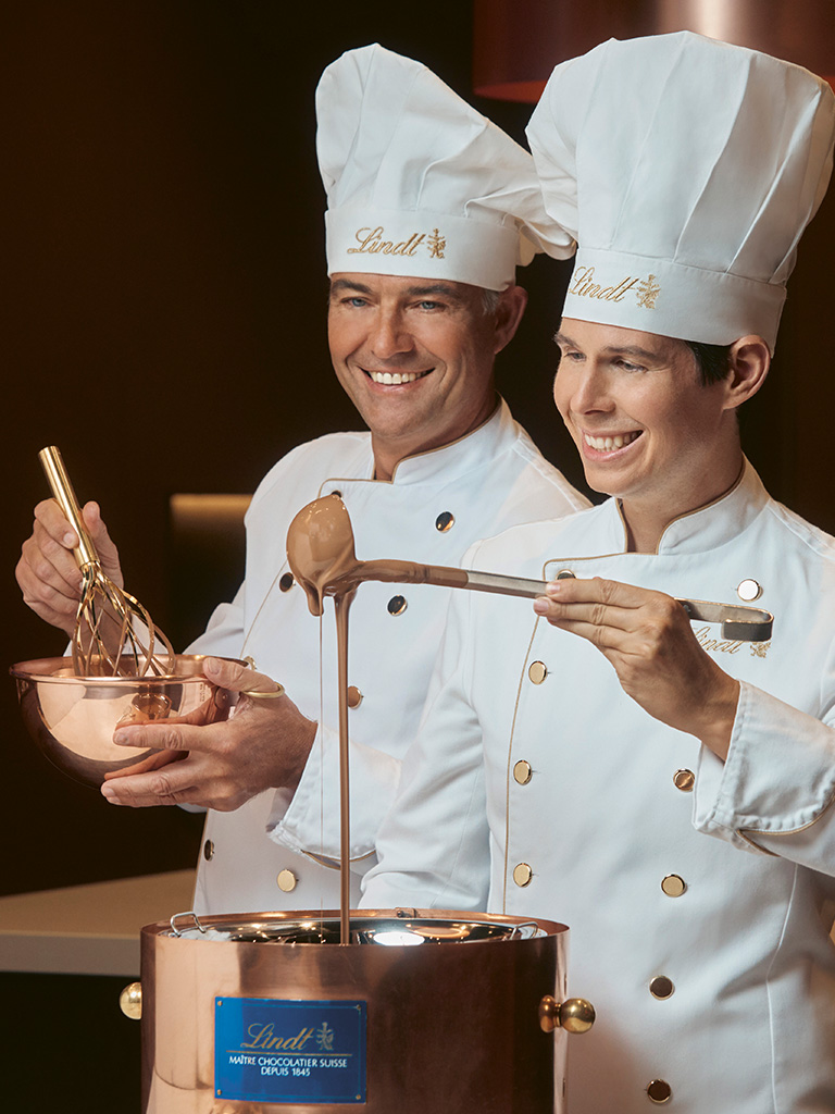 Two maîtres chocolatiers preparing chocolate (Photo)