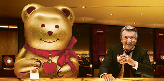 Ernst Tanner and a Lindt Chocolate Bear drink a glass of milk (Photo)