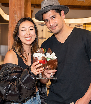 Two people pose for a photo with their Ghiradelli Hot Fudge Sundaes (Photo)