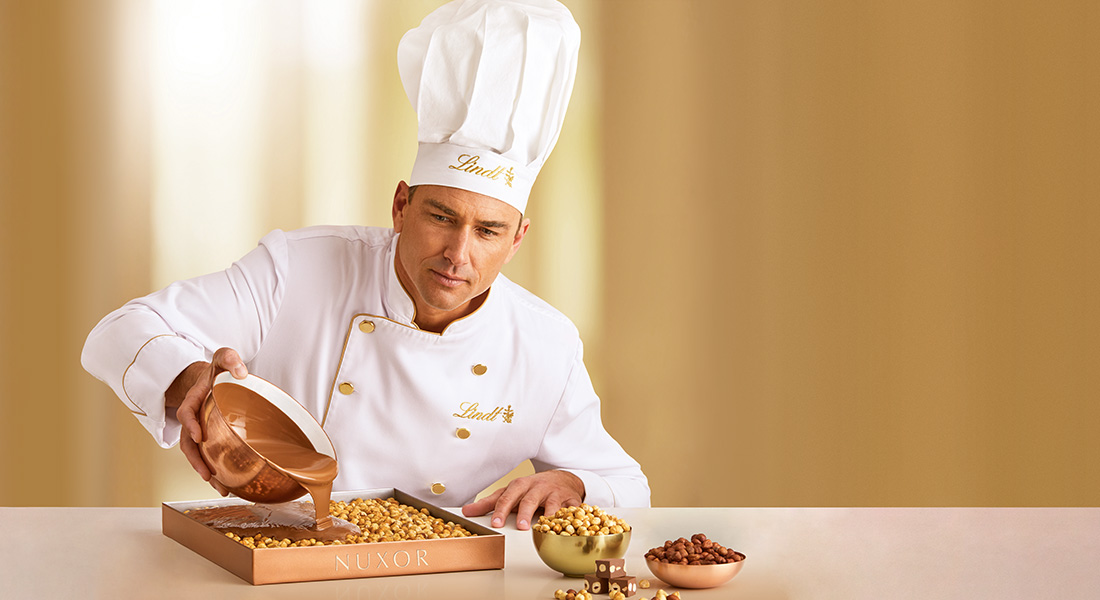 A Master Chocolatier who pours chocolate over hazelnuts and creates Lindt NUXOR. (Photo)